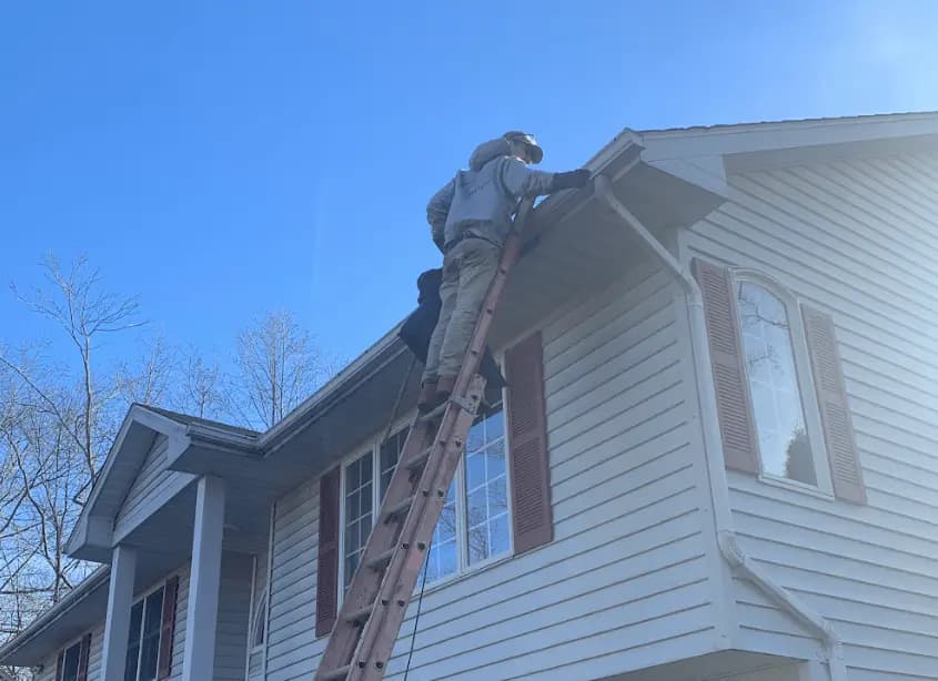 Gutter cleaning and maintenance being performed by Beachwood Power Washing in Beachwood